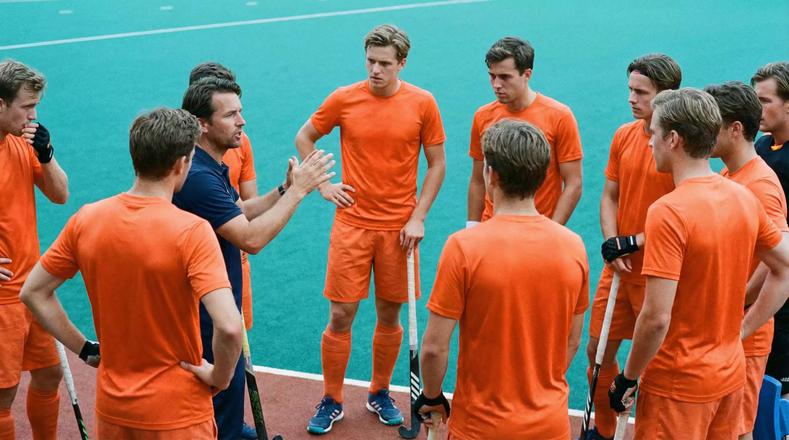Hockeycoach geeft instructies aan team tijdens time-out