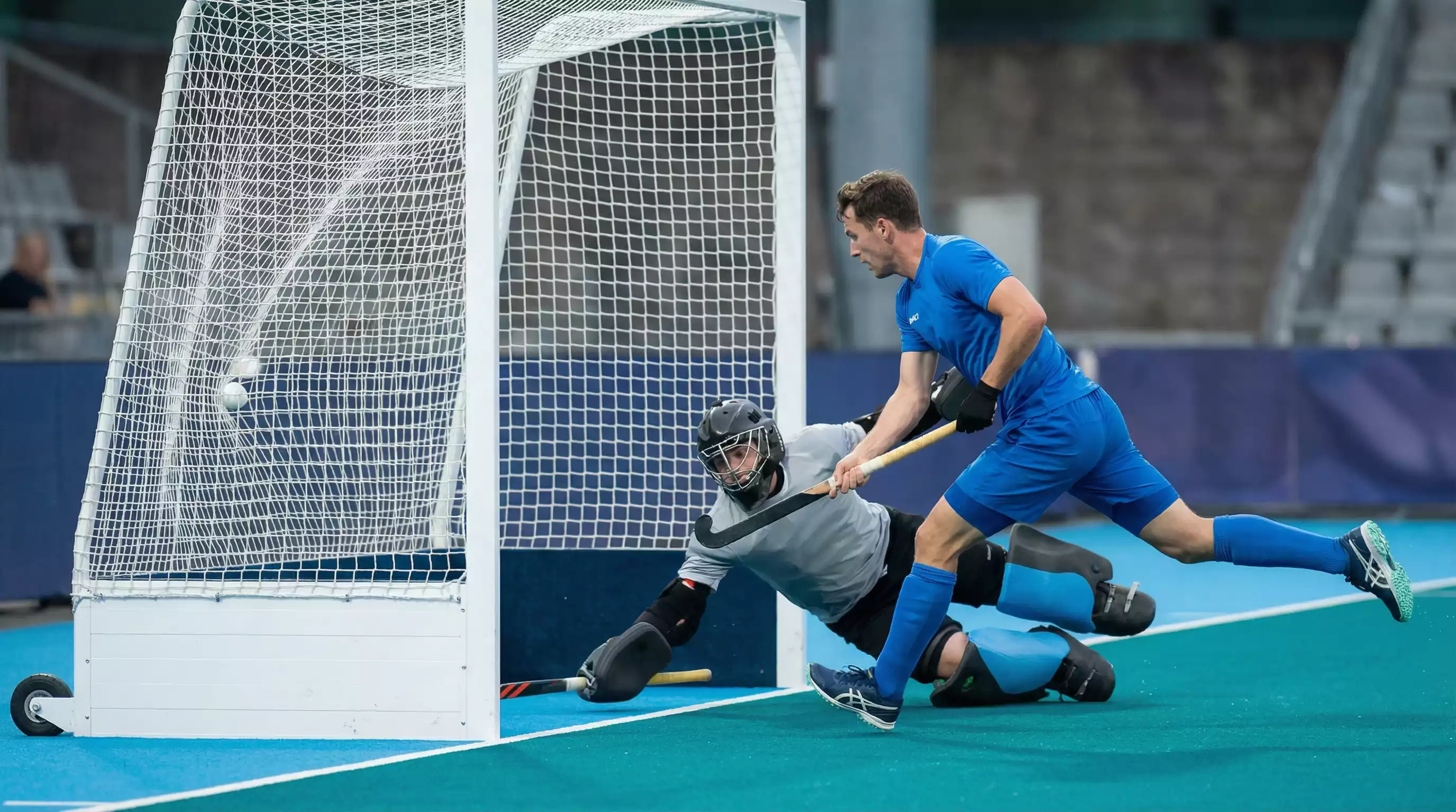Hockeyaanvaller scoort doelpunt uit open spel